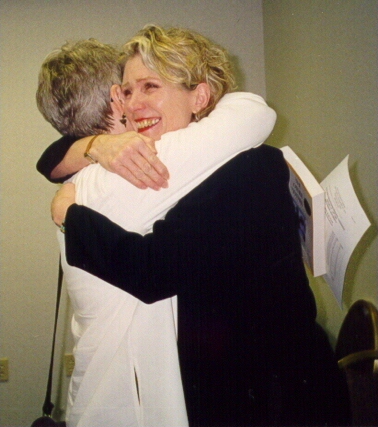 Author Carol Schaefer embraces unidentified conference attendee