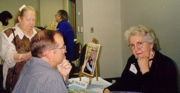 O.I. Vice President Lee Morgan chats with author Beth Kane in the Book Room